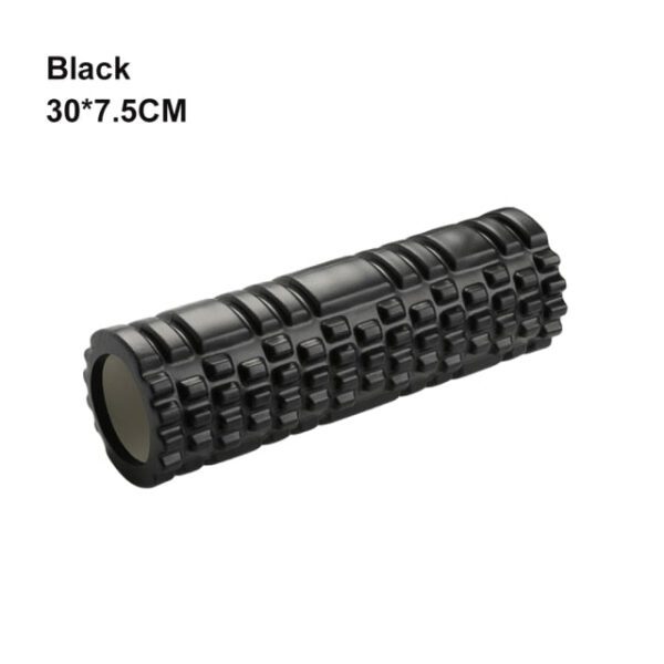 A black foam roller is sitting on top of the floor.