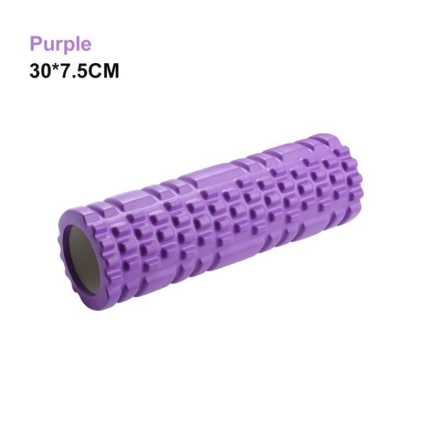 A purple foam roller is sitting on top of the floor.