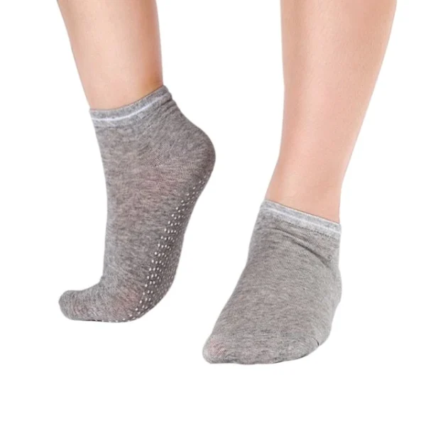 A person wearing grey socks with white trim.