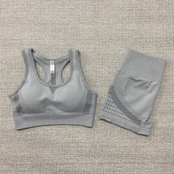 A pair of gray sports bras and shorts on the floor.