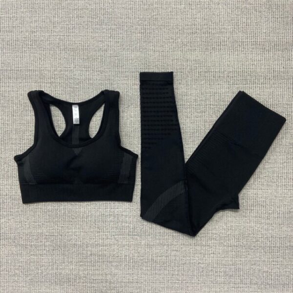 A black sports bra and leggings on top of a white background.