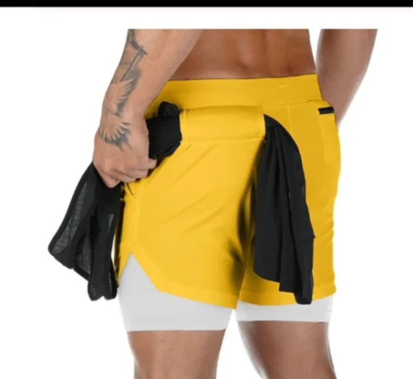 A man wearing yellow and white shorts with black trim.