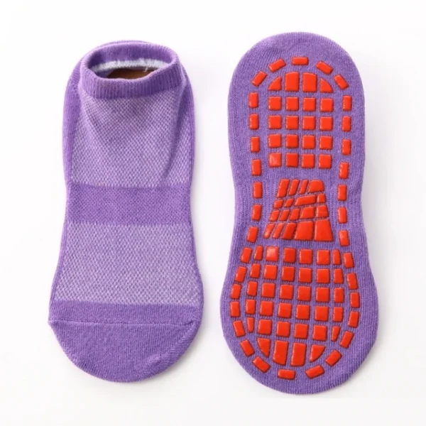 A pair of purple socks with red soles.