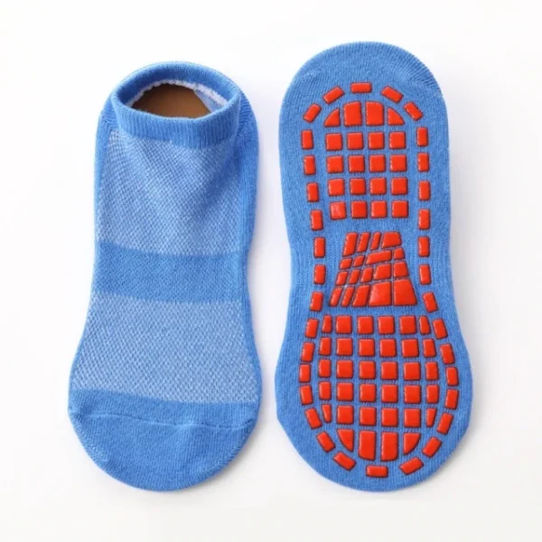 A pair of blue socks with an orange sole.