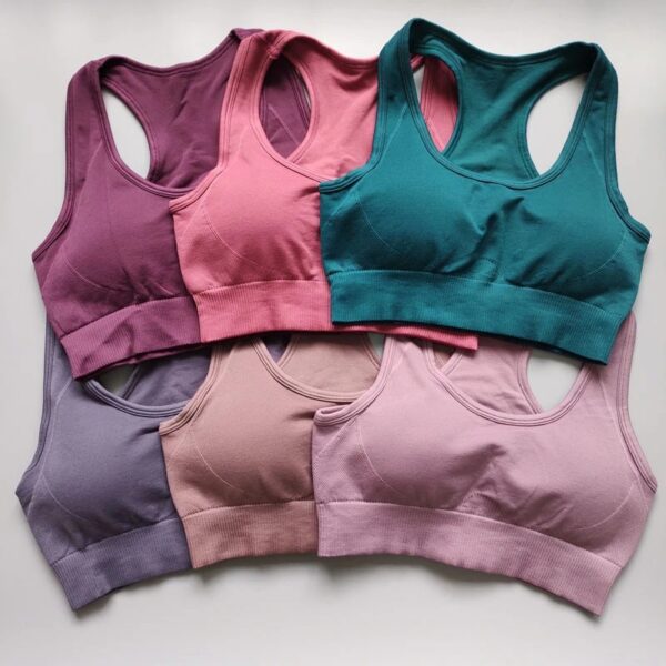 A group of six different colored sports bras.