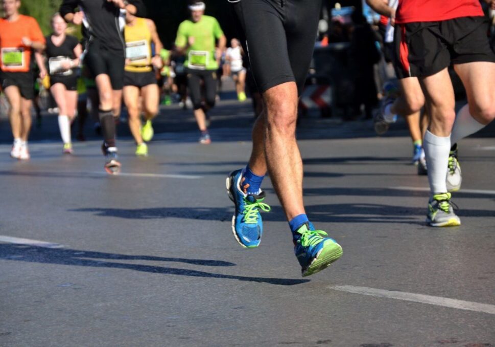 A group of people running in the street.