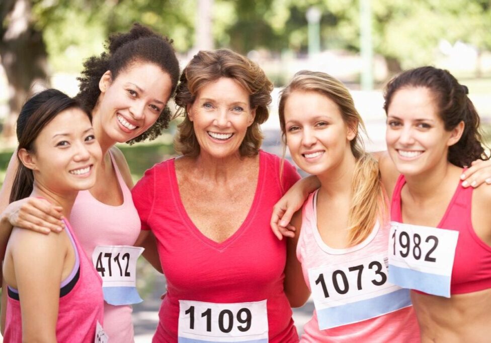 A group of women in pink and white numbered shirts.